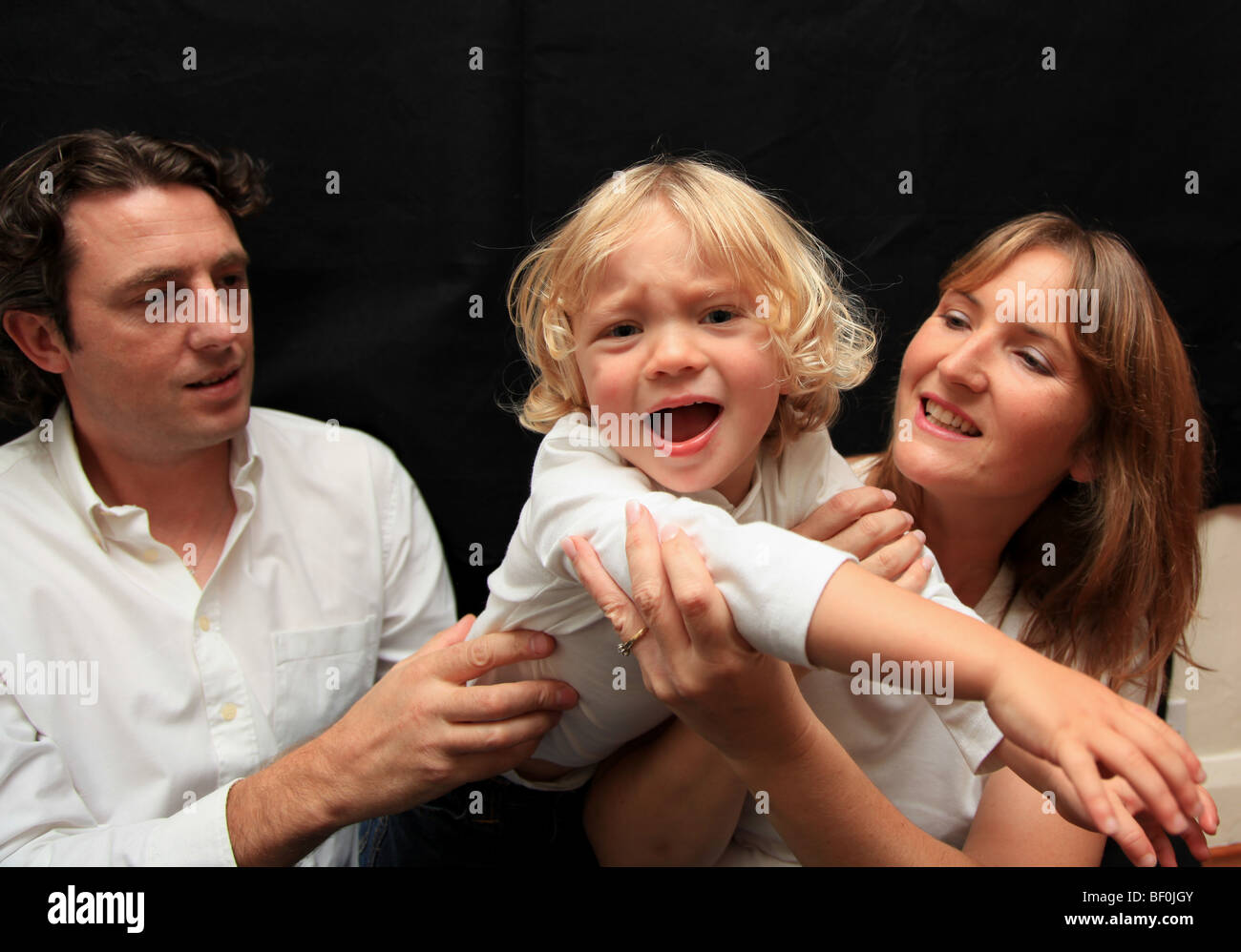 Mum and dad with toddler son Stock Photo