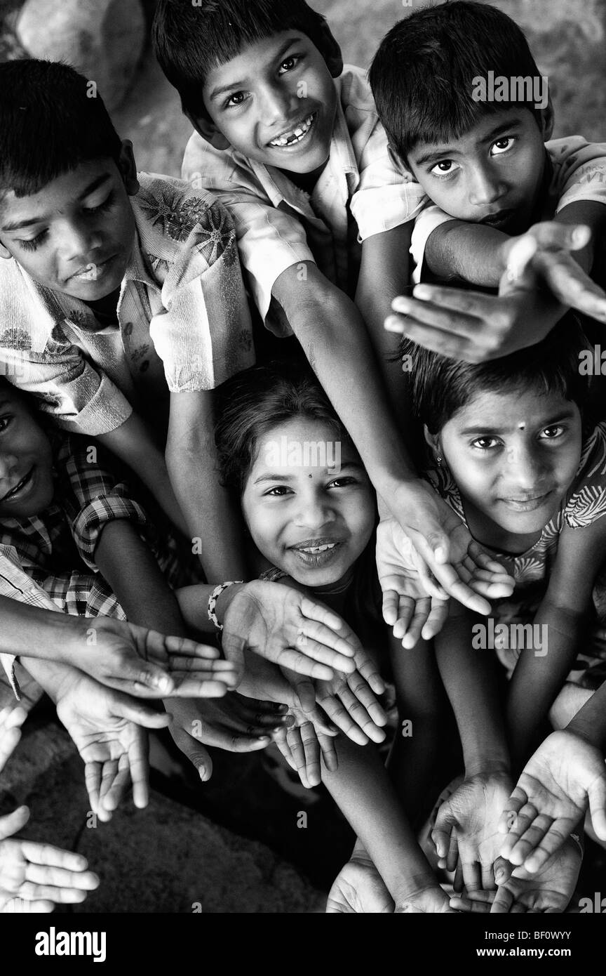 Indian children playing together huddled in a group. India. Black and White. Stock Photo