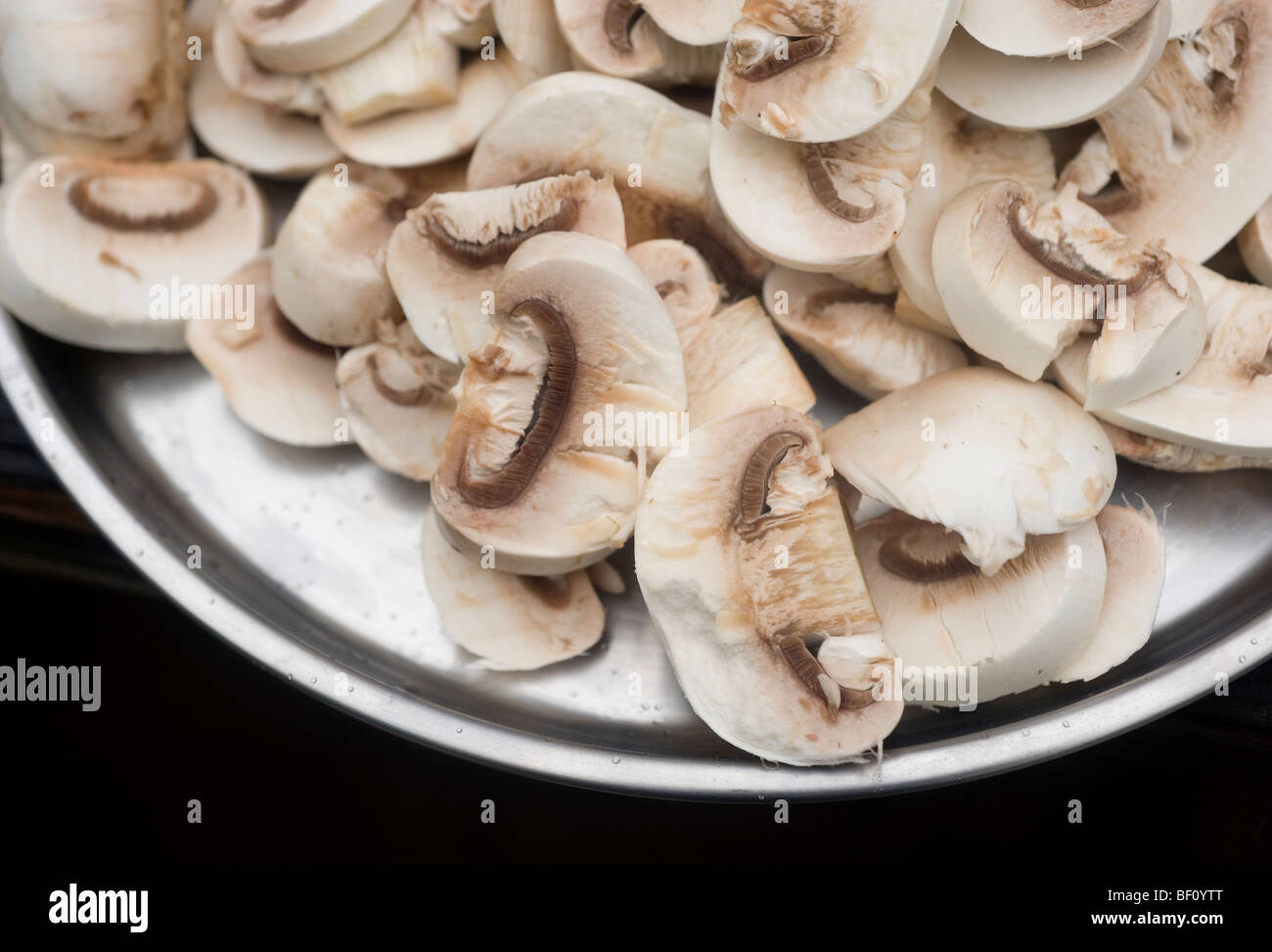 Sliced mushrooms on an aluminum plate. Stock Photo