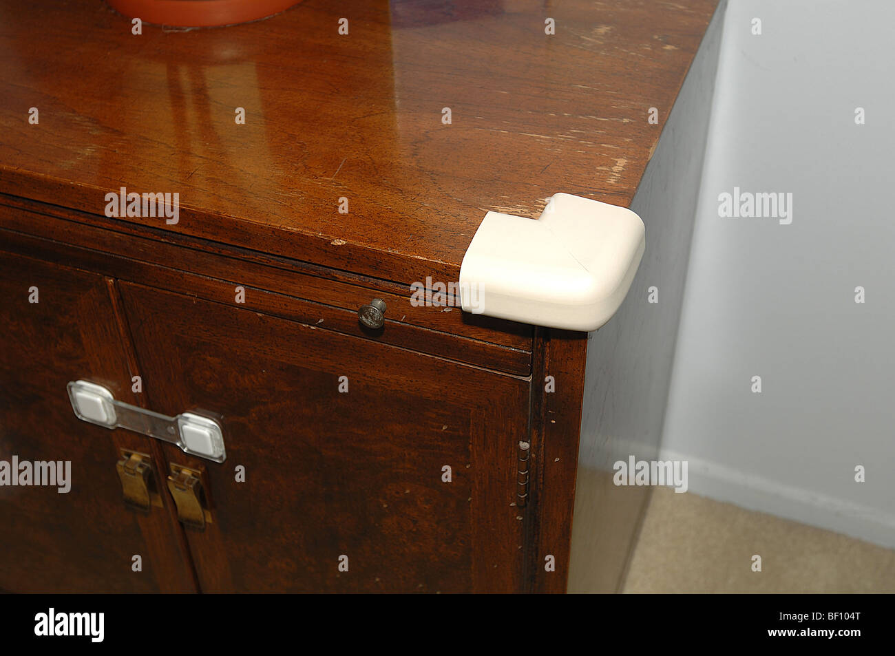 Child safety latch keeps doors closed and a foam bumper