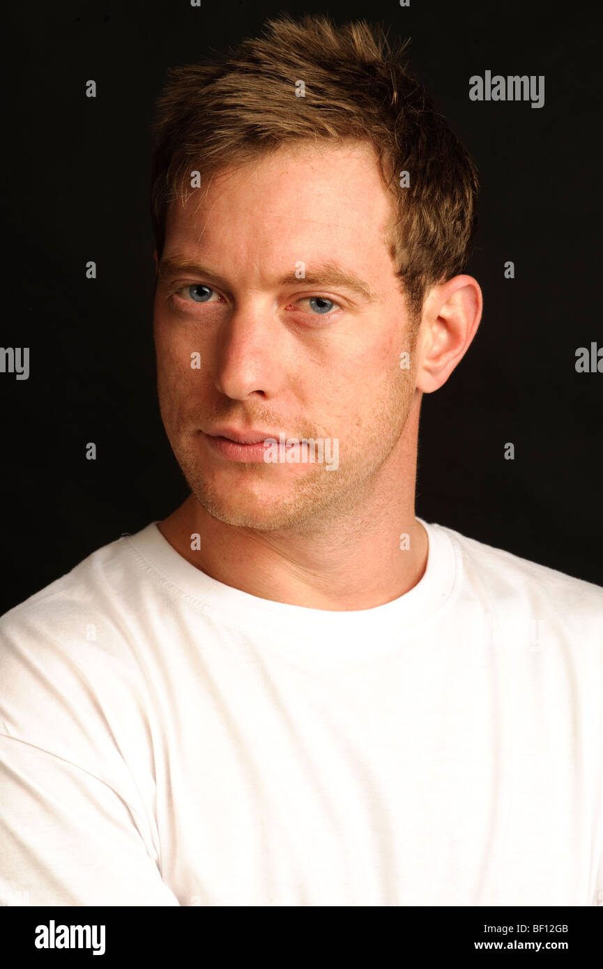 Studio portrait of a 30 something year old blue-eyed British man wearing a white t-shirt Stock Photo