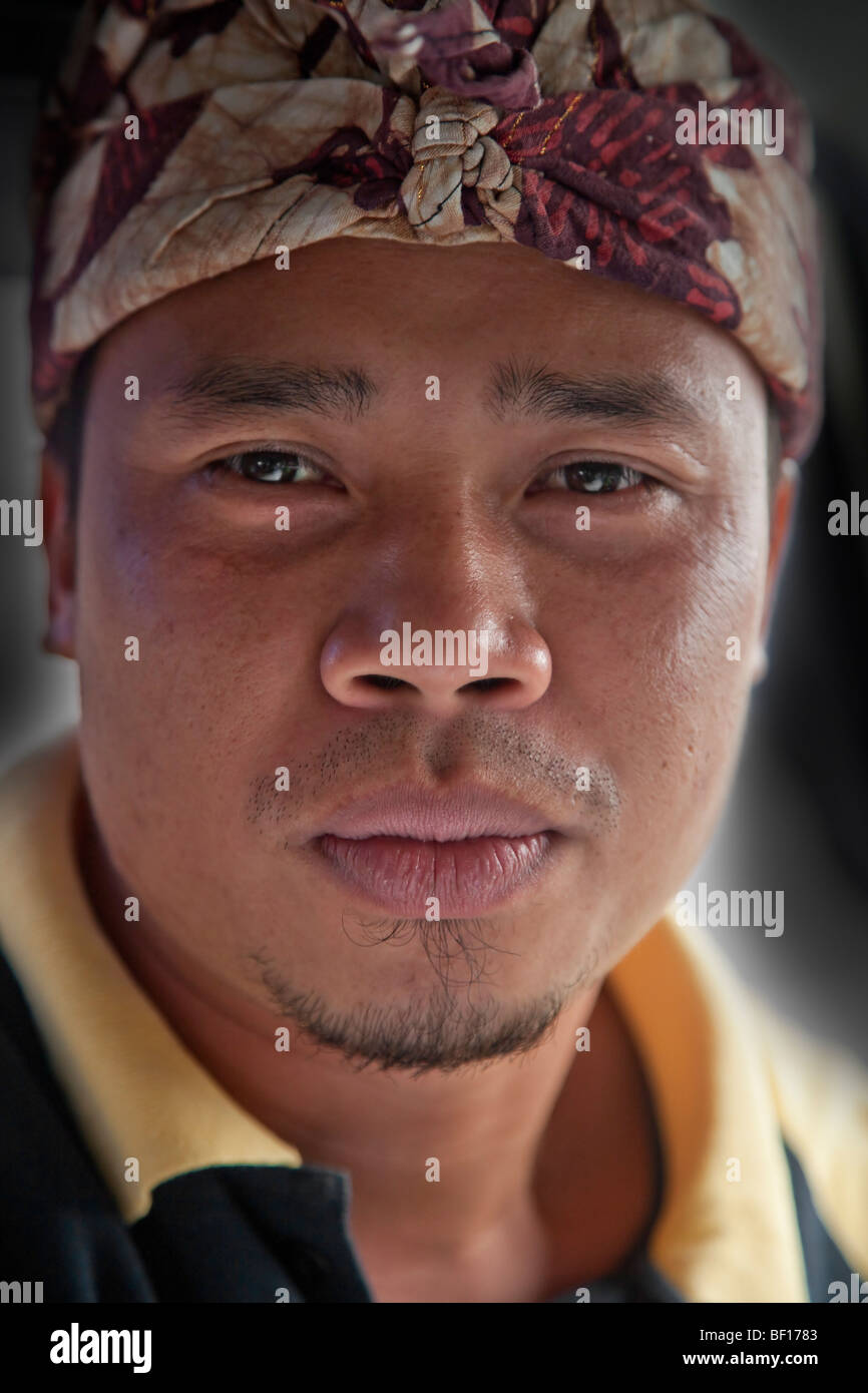 Face portrait Balinese man wearing local turban head scarf, Bali, Indonesia Stock Photo