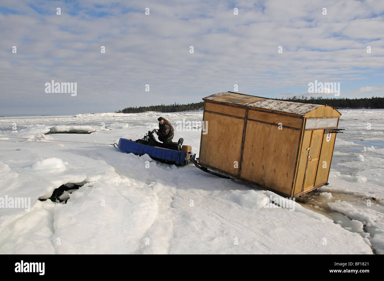 ski doo and ice camp hut close to the shore, White Sea, Russia Stock
