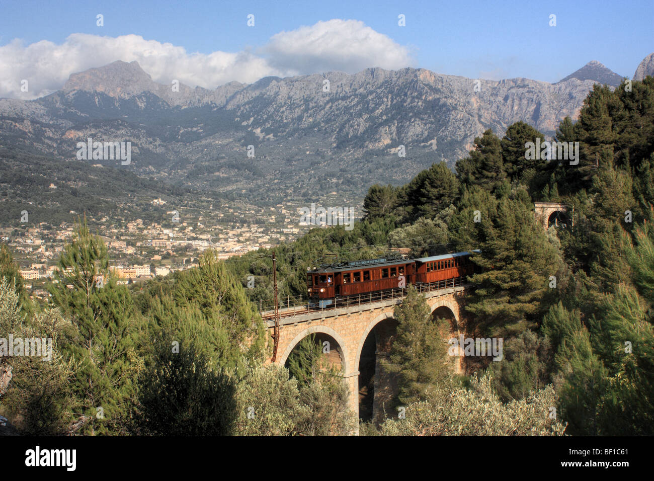 Historic train crossing the viaduct Cinc-Ponts in front of Sóller, Majorca Island, Spain Stock Photo