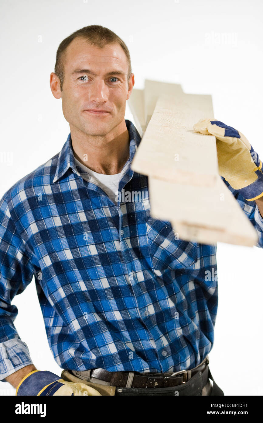 A craftsman carrying planks Stock Photo Alamy