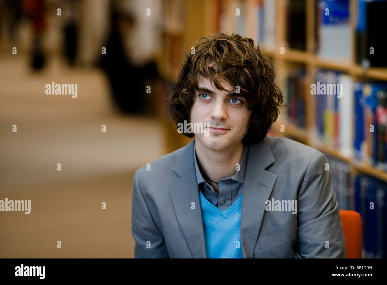 A male student in a library, Sweden. Stock Photo