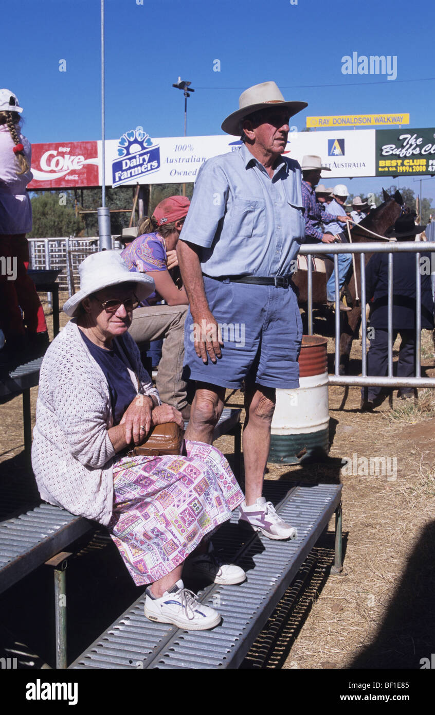 Elderly couple in traditional Ozzie dress, hats, shorts and skirt, Rodeo Queensland Australia Stock Photo