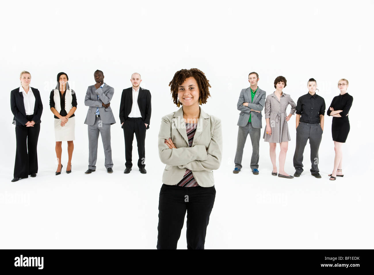 A young professional standing in front of a row of business people Stock Photo