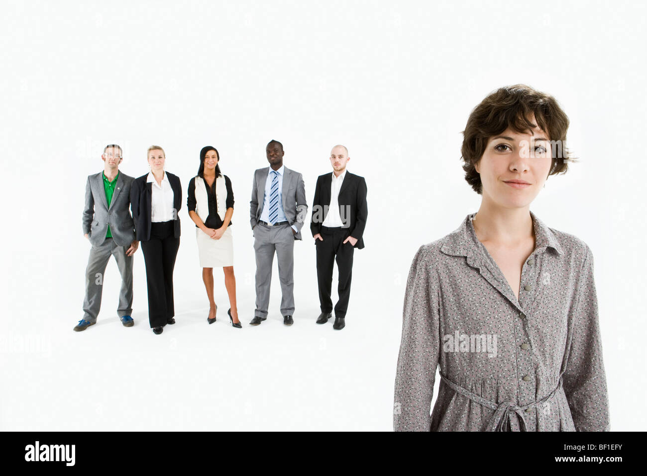 A young professional in front of a row of business people Stock Photo