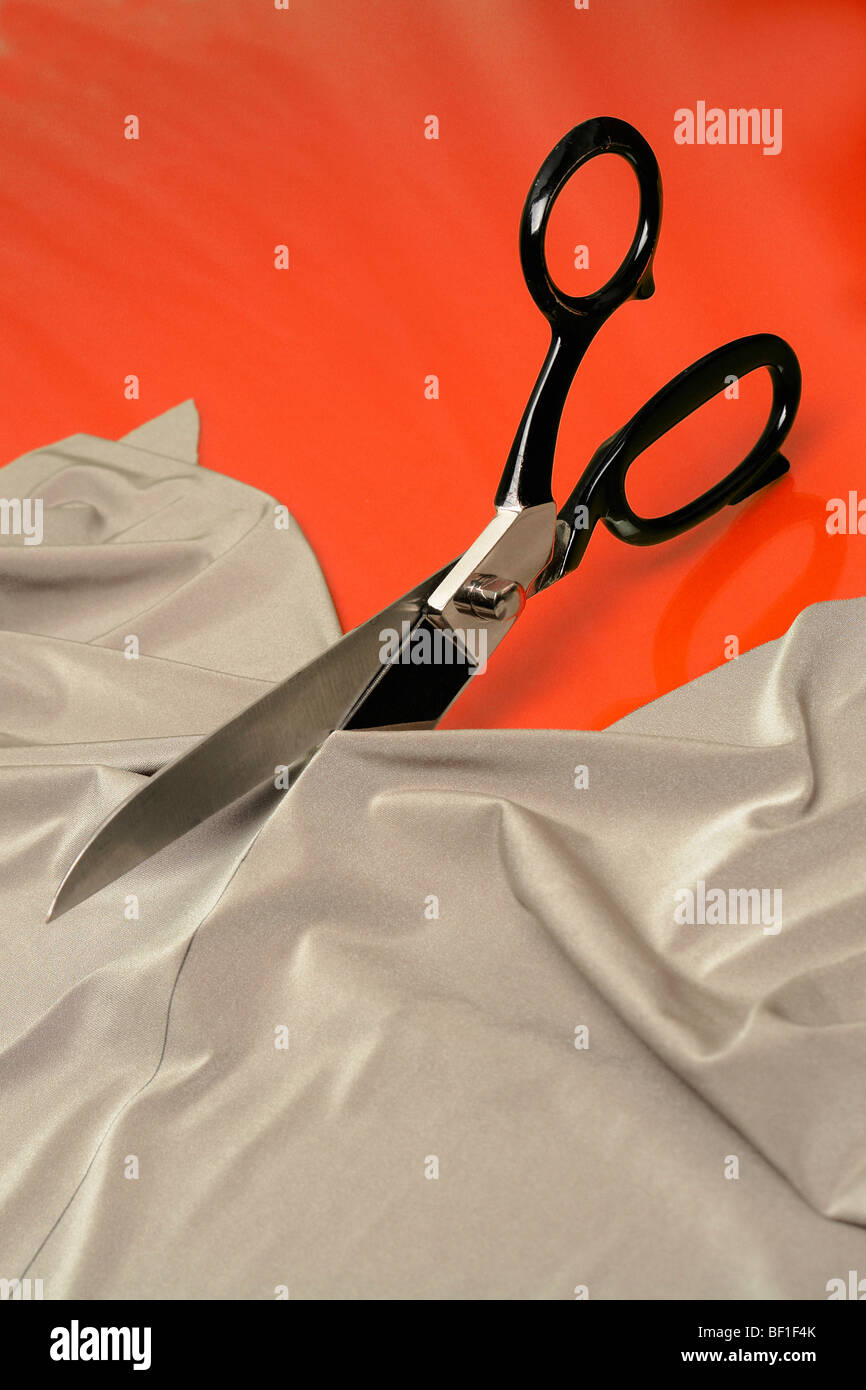 Detail of scissors cutting fabric Stock Photo
