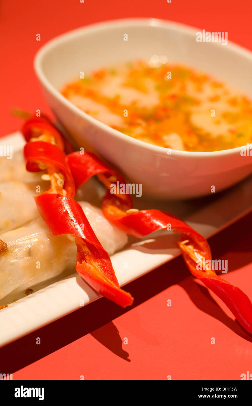 Detail of rice paper rolls and a dipping sauce Stock Photo