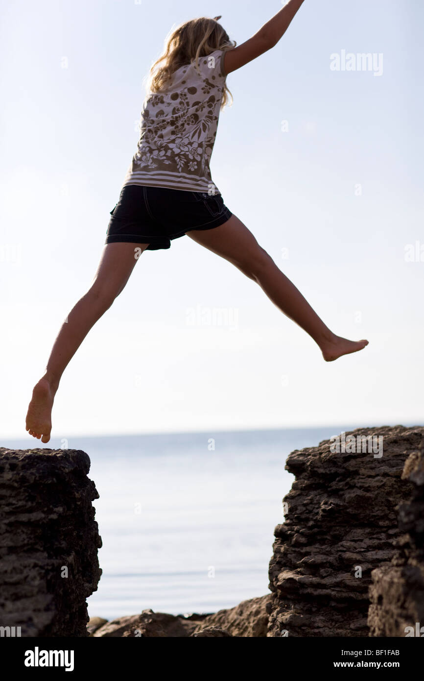A girl jumping on rocks, Sweden Stock Photo - Alamy