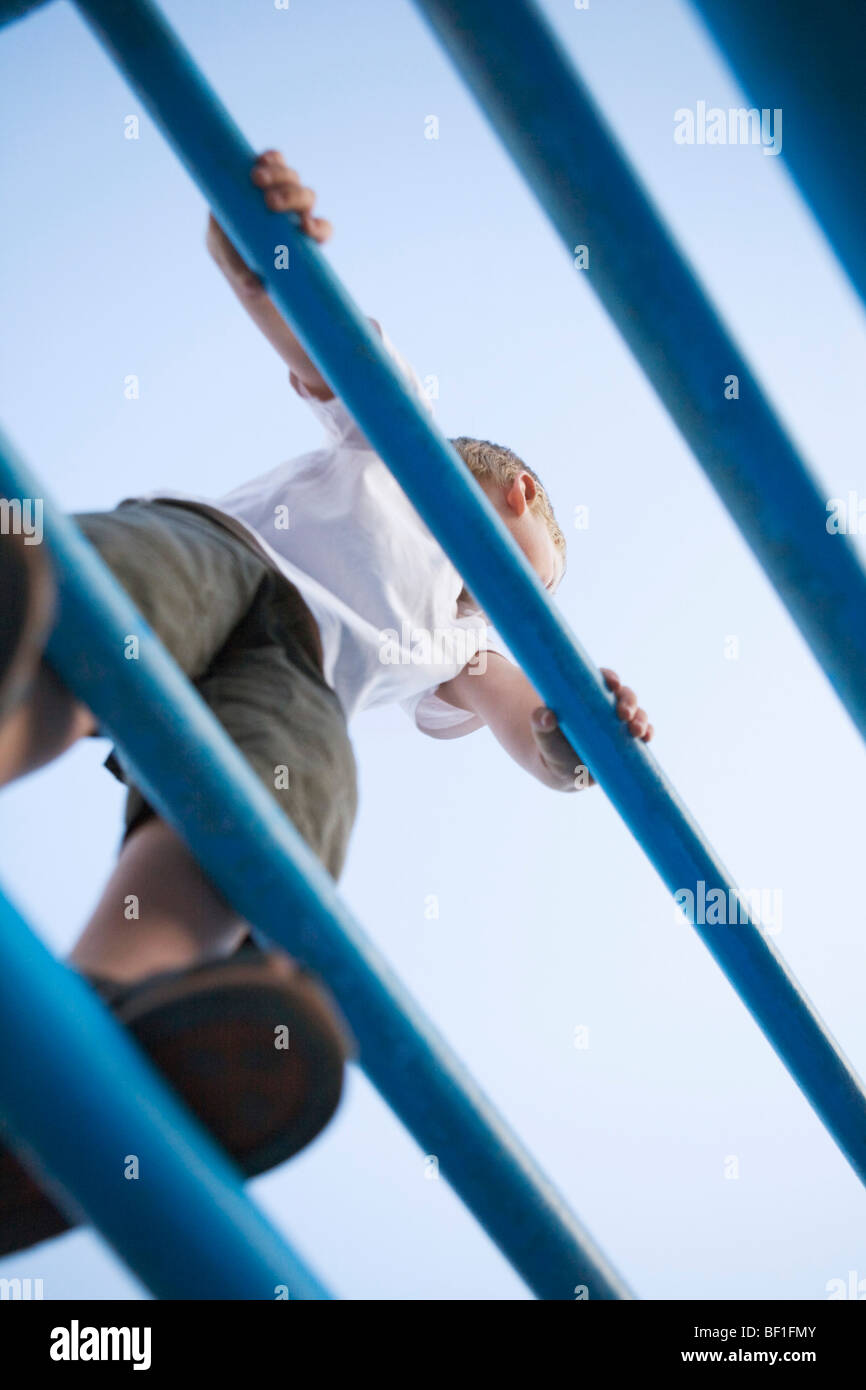 A boy standing on a jungle gym Stock Photo