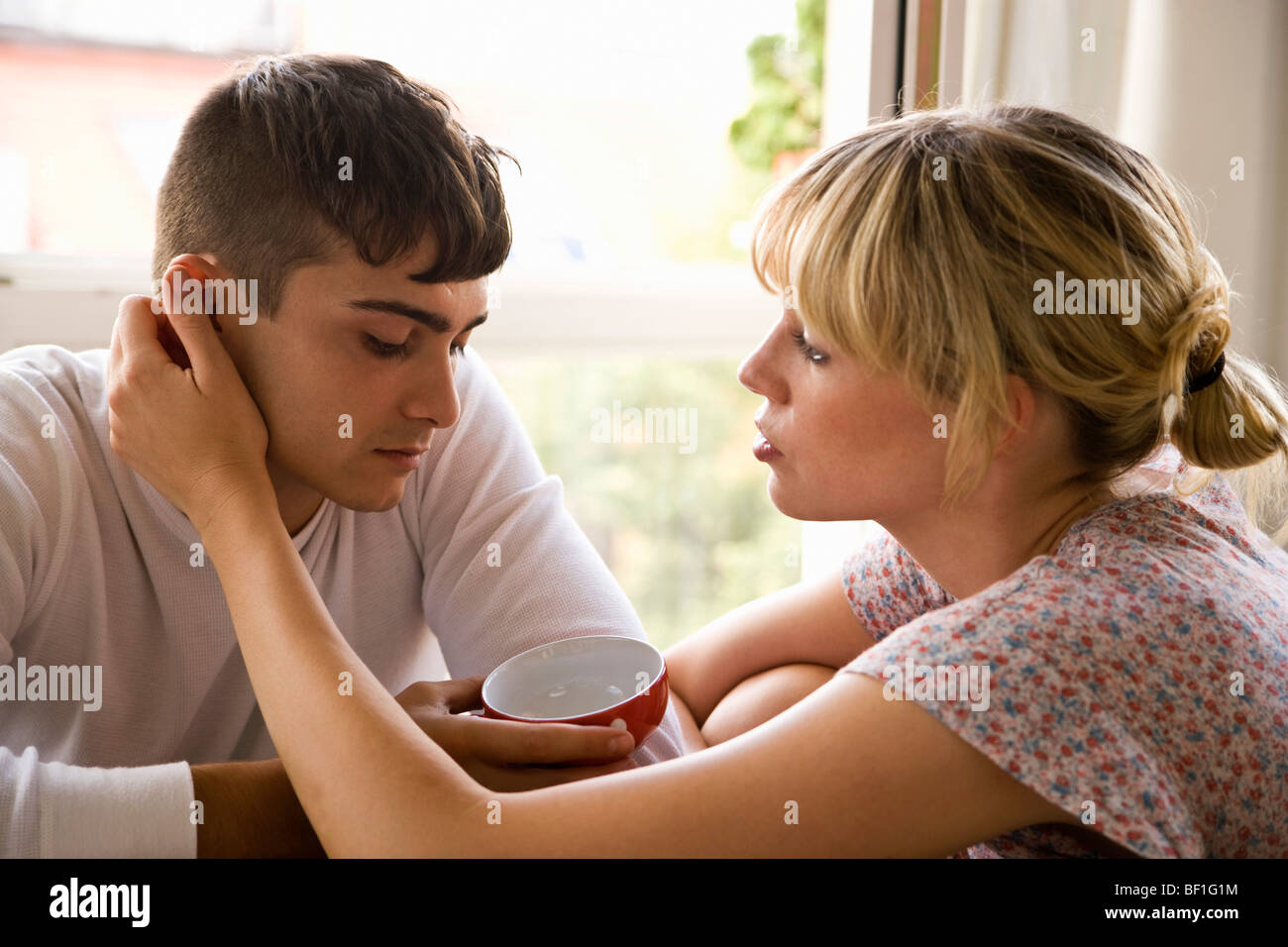 A girlfriend comforting her boyfriend Stock Photo