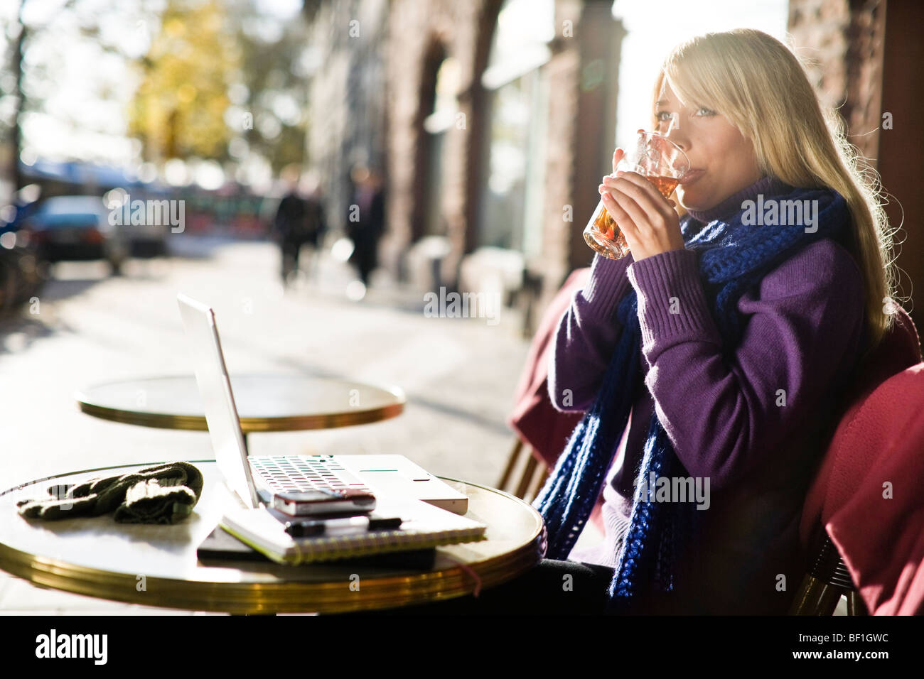 Young woman sitting in a cafe using a laptop, Sweden. Stock Photo