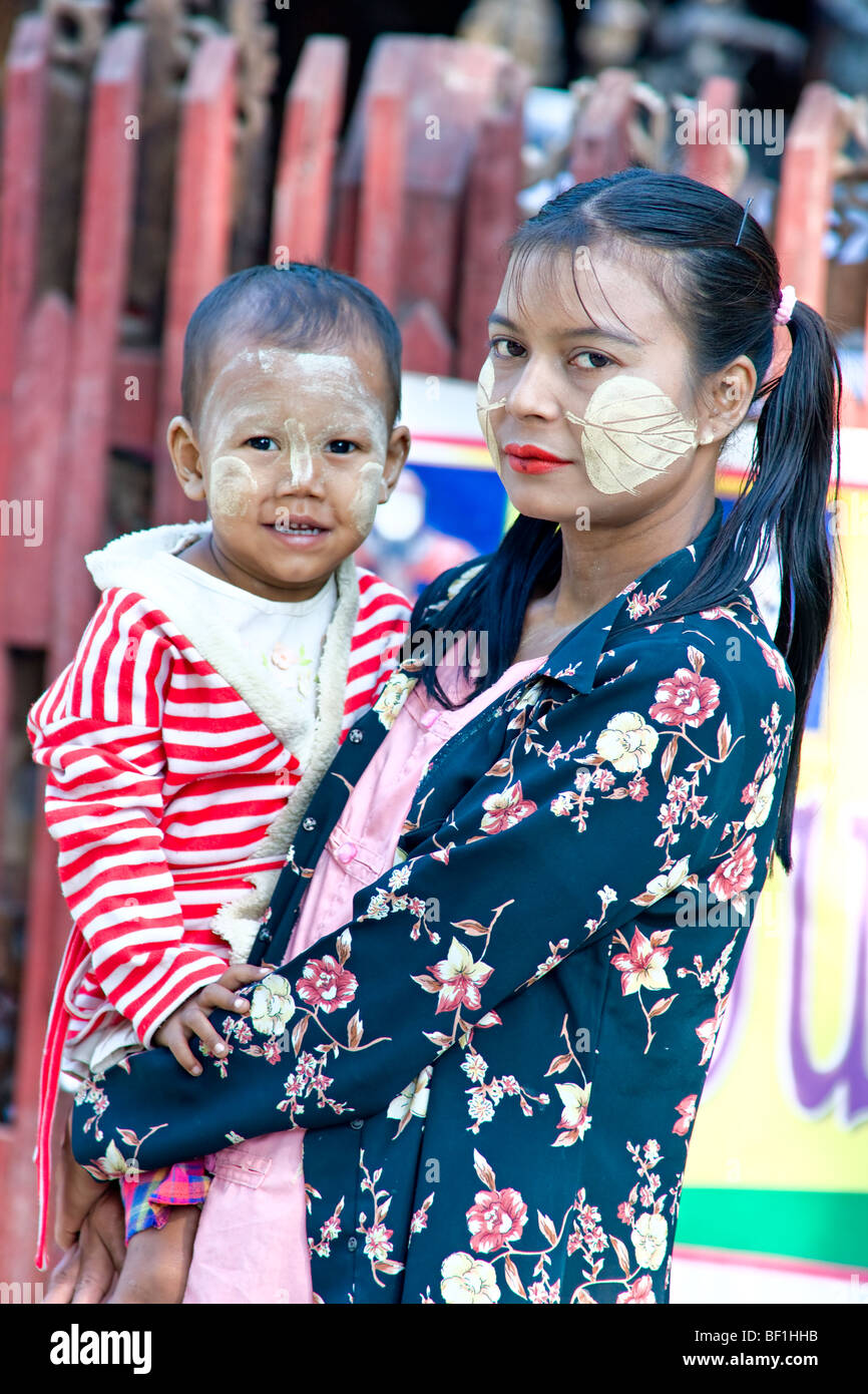 Portrait of a young burmese with her son, with tanaka in the faces, Mandalay, Myanmar. Stock Photo