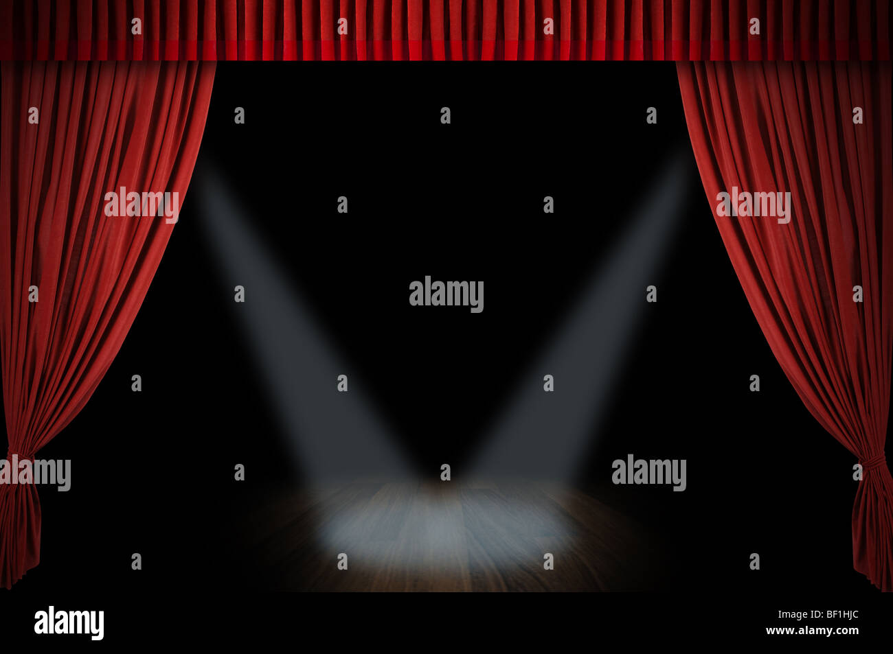 Large red curtain stage opening with spot lights and dark background ...
