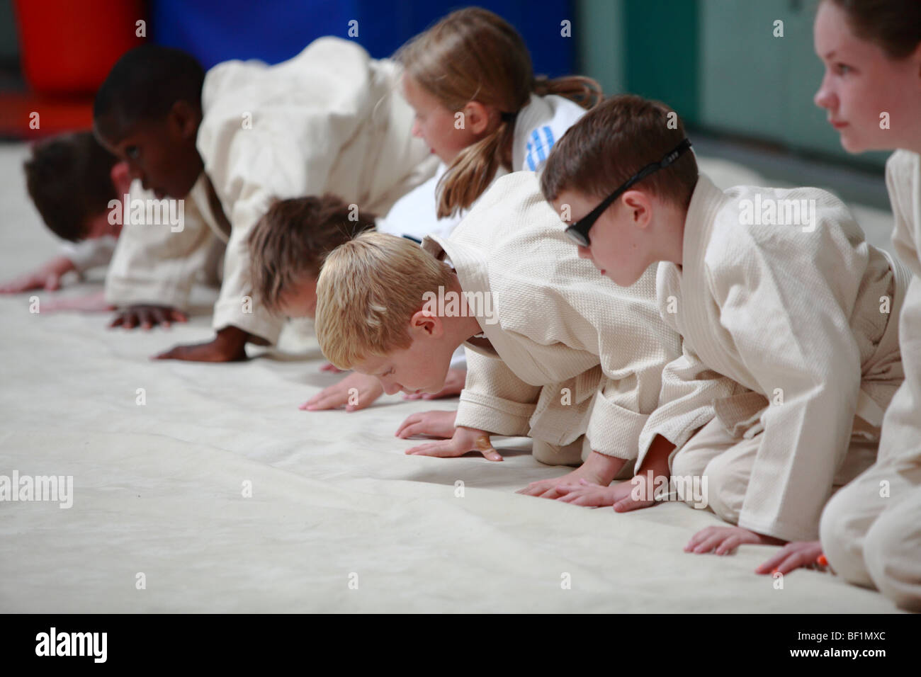 A judo class for kids and children with adults supervising the training