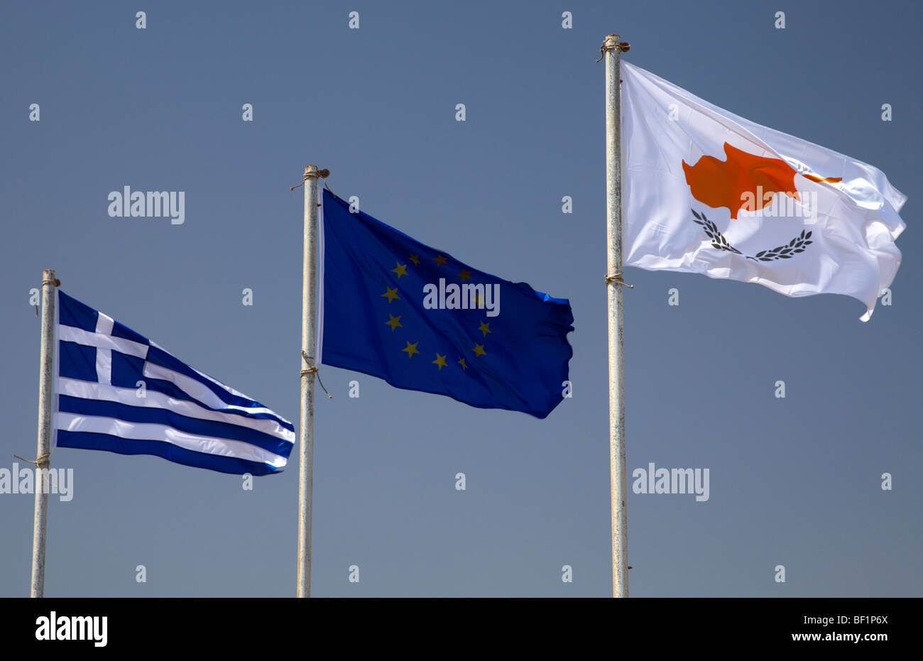 greek republic of cyprus and eu flags flying in a blue sky in cyprus Stock Photo