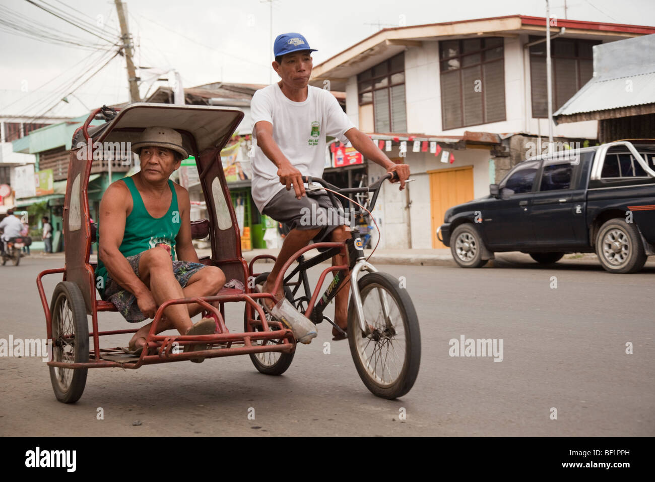 Man riding in a tricycle taxi. Passi City Iloilo Philippines Stock Photo