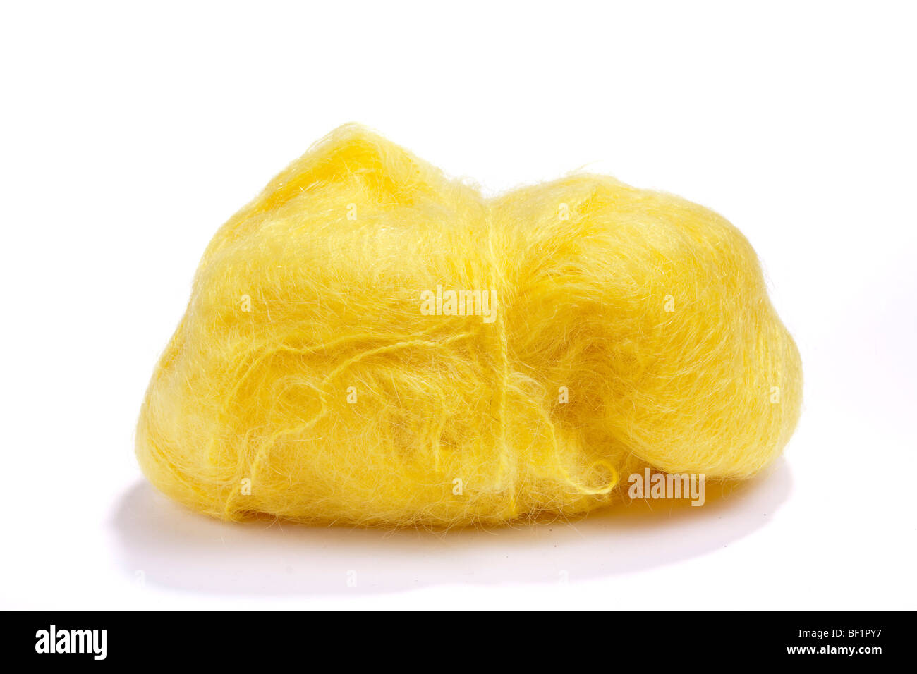 Large ball of yellow mohair wool or yarn against white background. Stock Photo