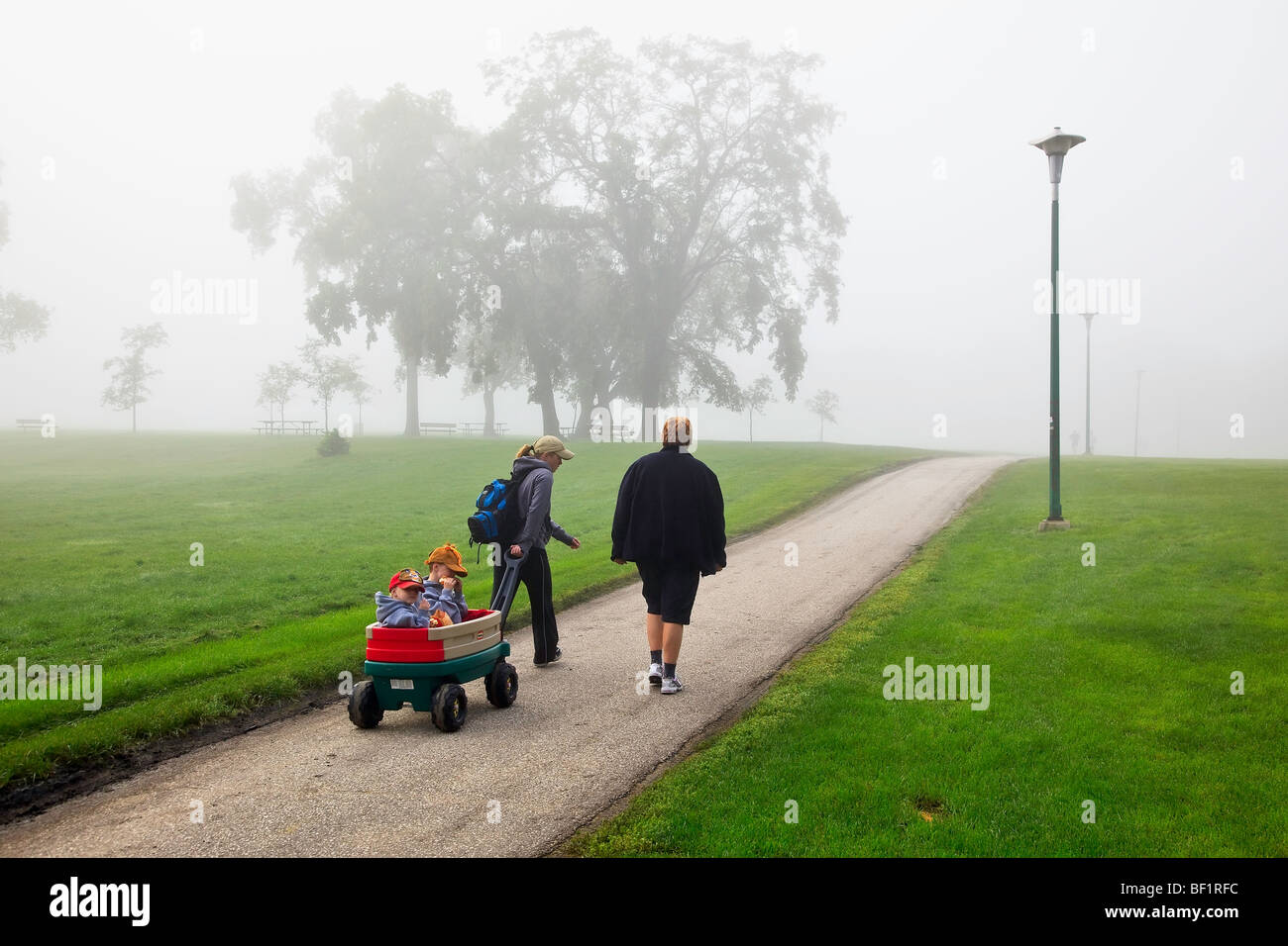 Multi-generation family on a foggy morning walk, Assiniboine Park, Winnipeg, Manitoba, Canada. Stock Photo