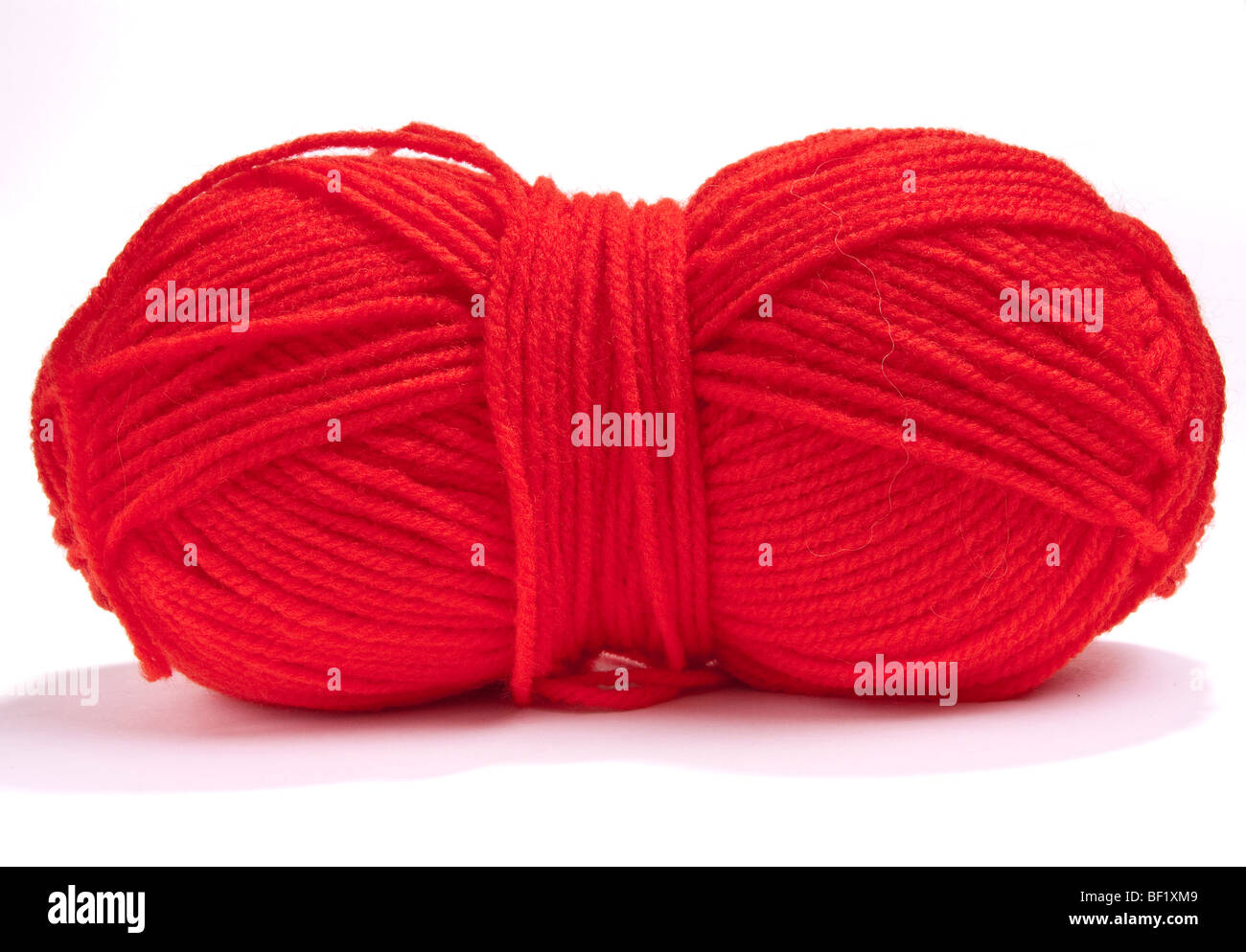 Large ball of red mohair wool or yarn  against white background. Stock Photo