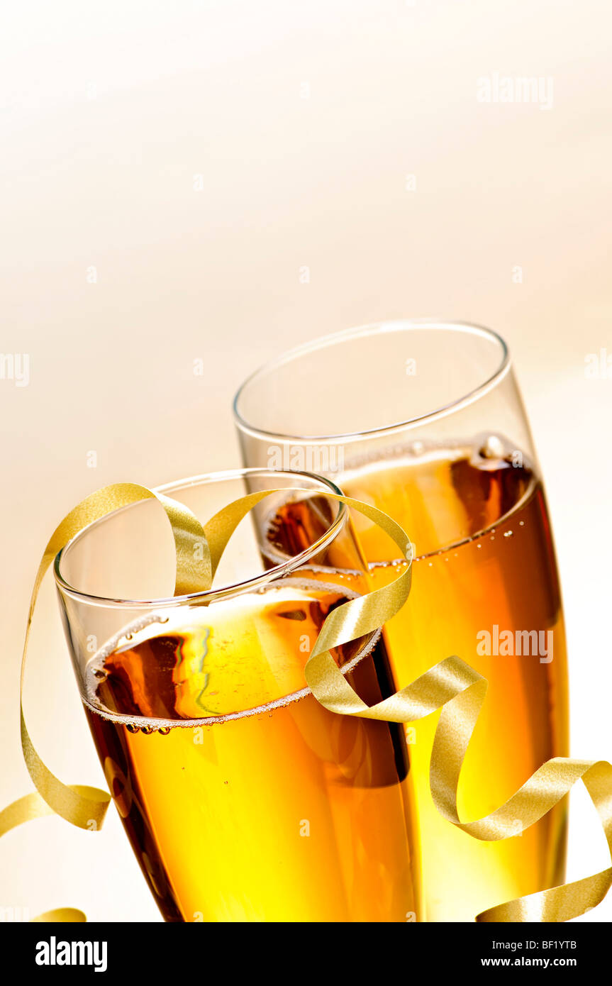 Two full champagne flutes with sparkling wine and ribbon Stock Photo