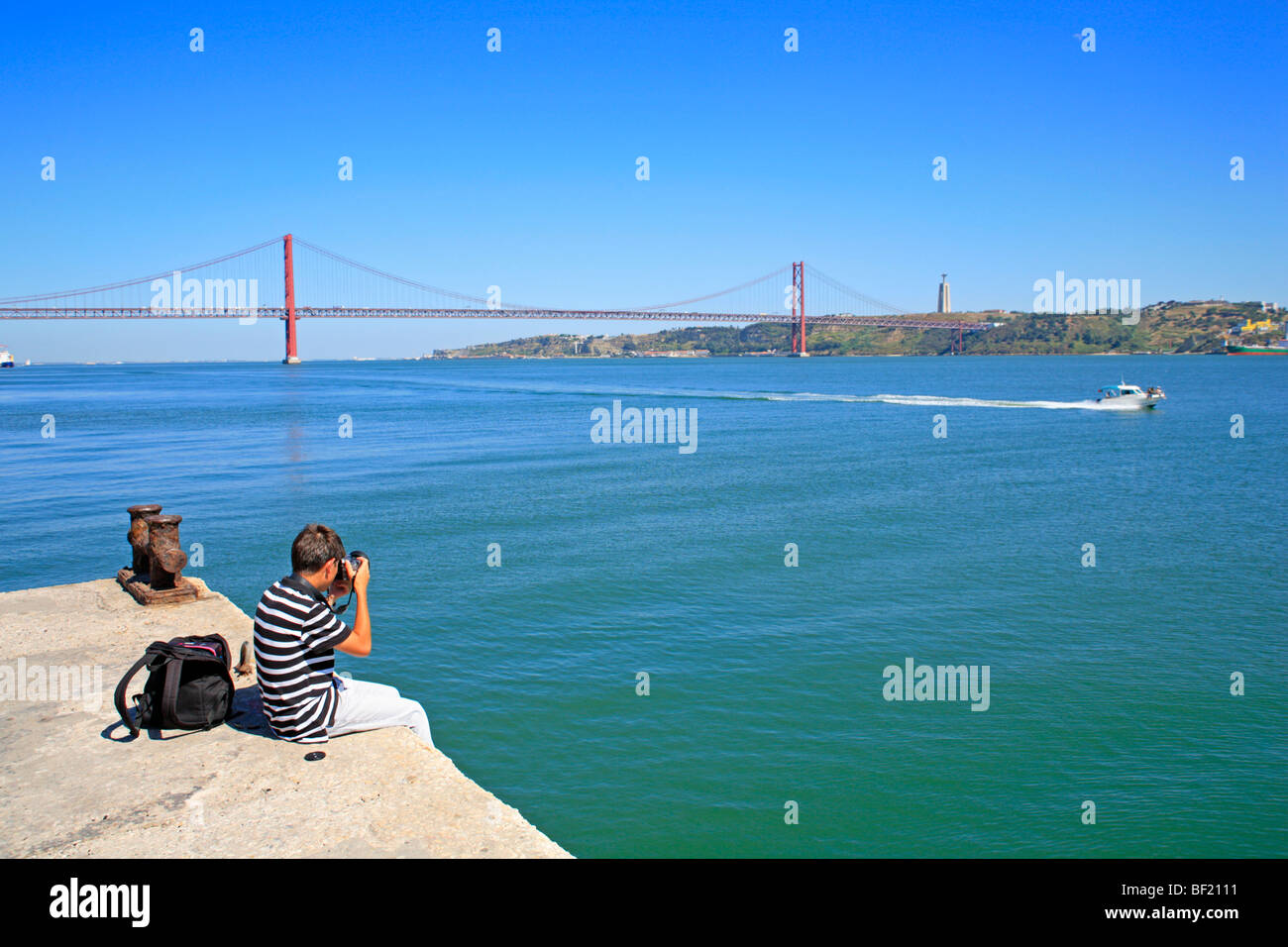 Ponte 25 de Abril and statue of Christ, Lisbon, Portugal Stock Photo