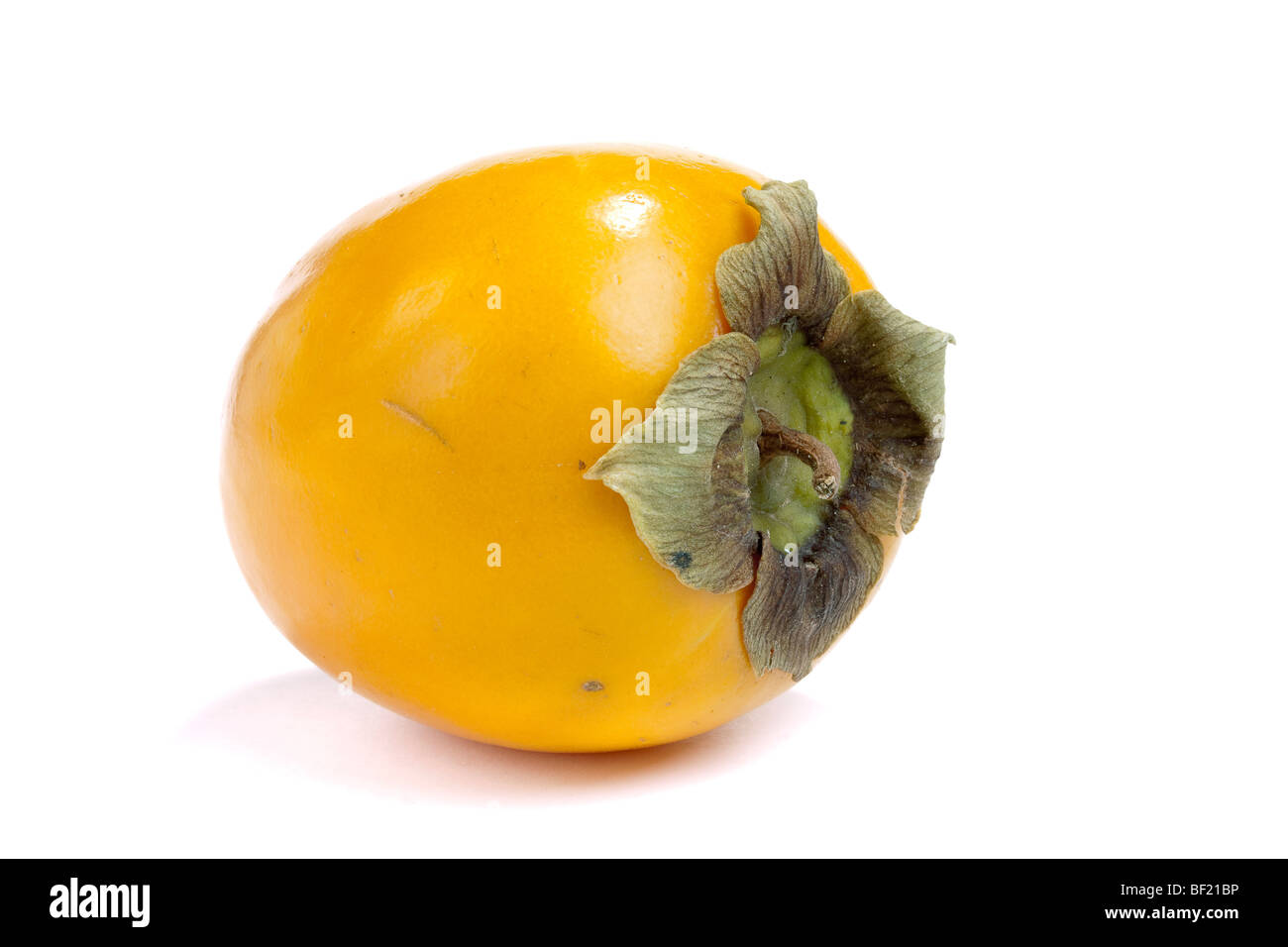 Single sharon fruit isolated against white background. Stock Photo