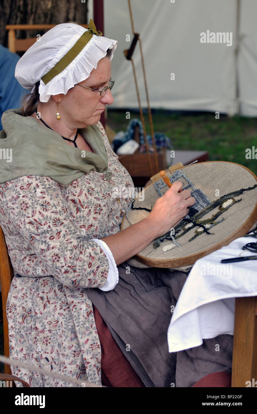Woman stitching - costumed American Revolutionary War (1770's) era re-enactment Stock Photo