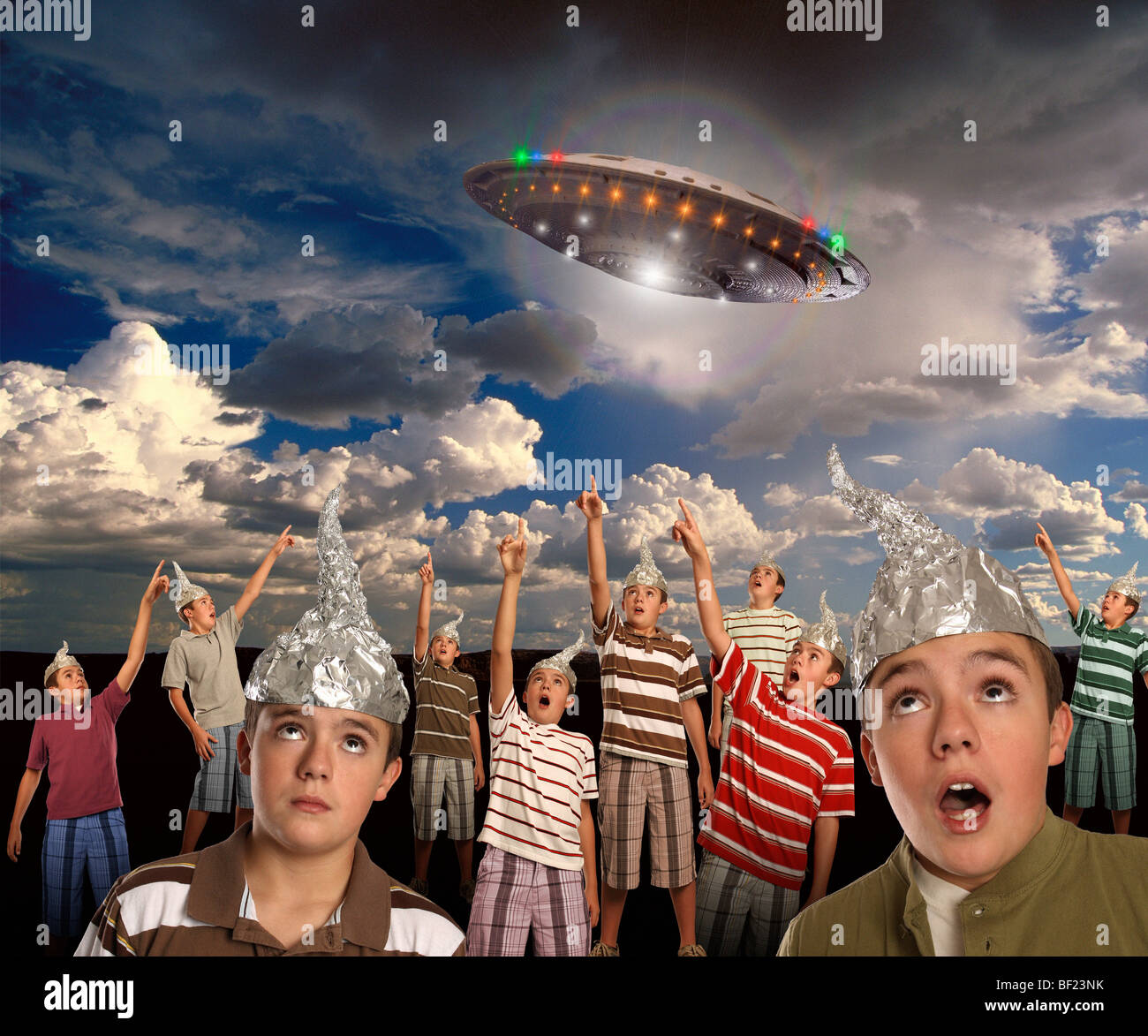 A group of CLONES wearing tin-foil hats points to a UFO in the sky! Stock Photo