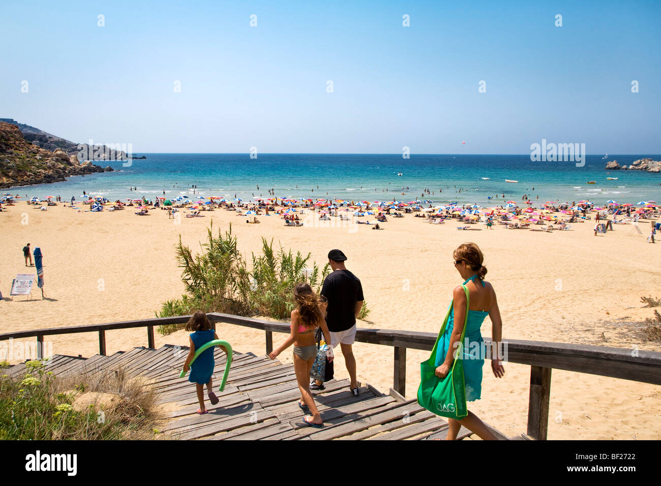 People going downstairs to the beach, Golden Bay, Malta, Europe Stock Photo