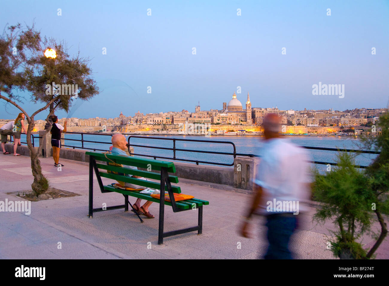 People at the promenade in the evening, view at Valletta, Sliema, Malta, Europe Stock Photo