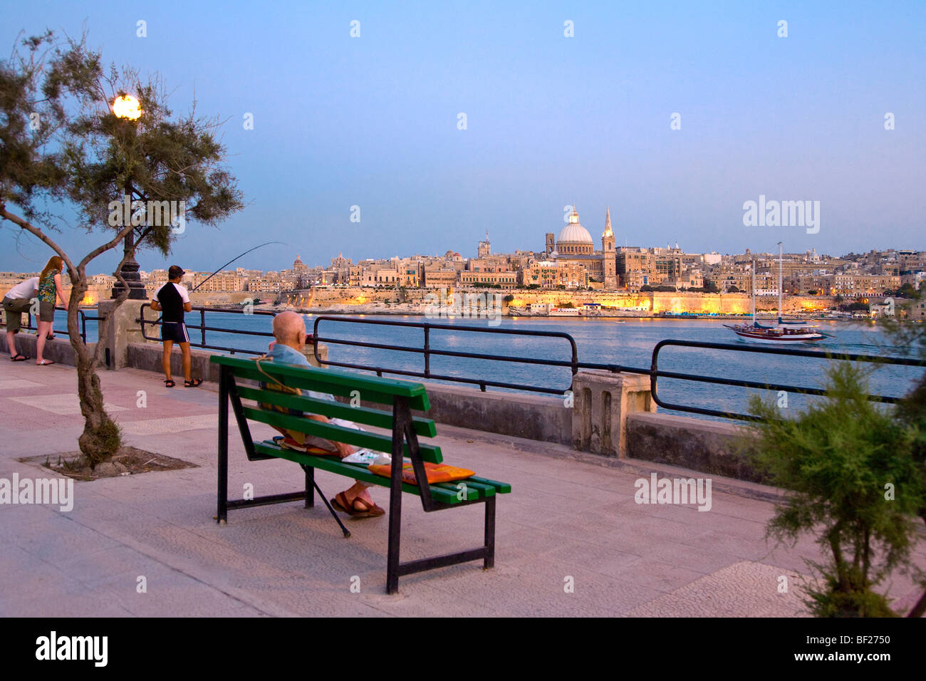 People at the promenade in the evening, view at the town Valletta, Sliema, Malta, Europe Stock Photo