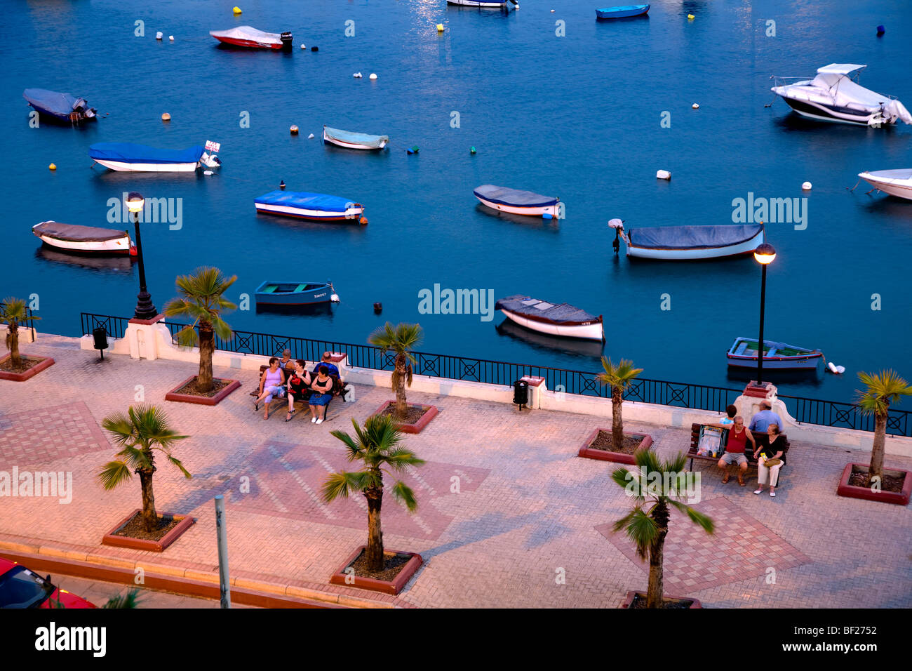 People at the promenade in the evening, Marsamxett Harbour, Sliema Creek, Sliema, Malta, Europe Stock Photo