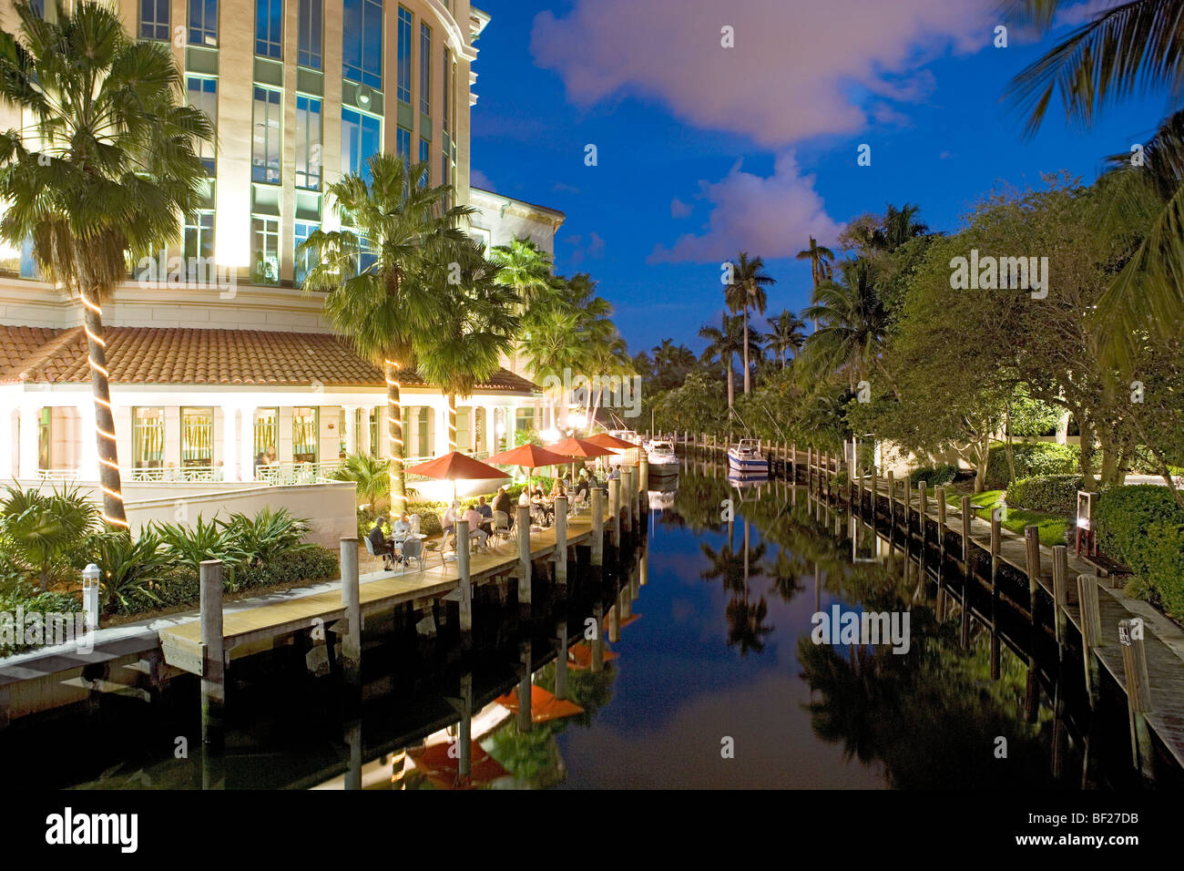 People sitting on the illuminated terrace of the Wild East Grill restaurant in the evening, Fort Lauderdale, Florida, USA Stock Photo