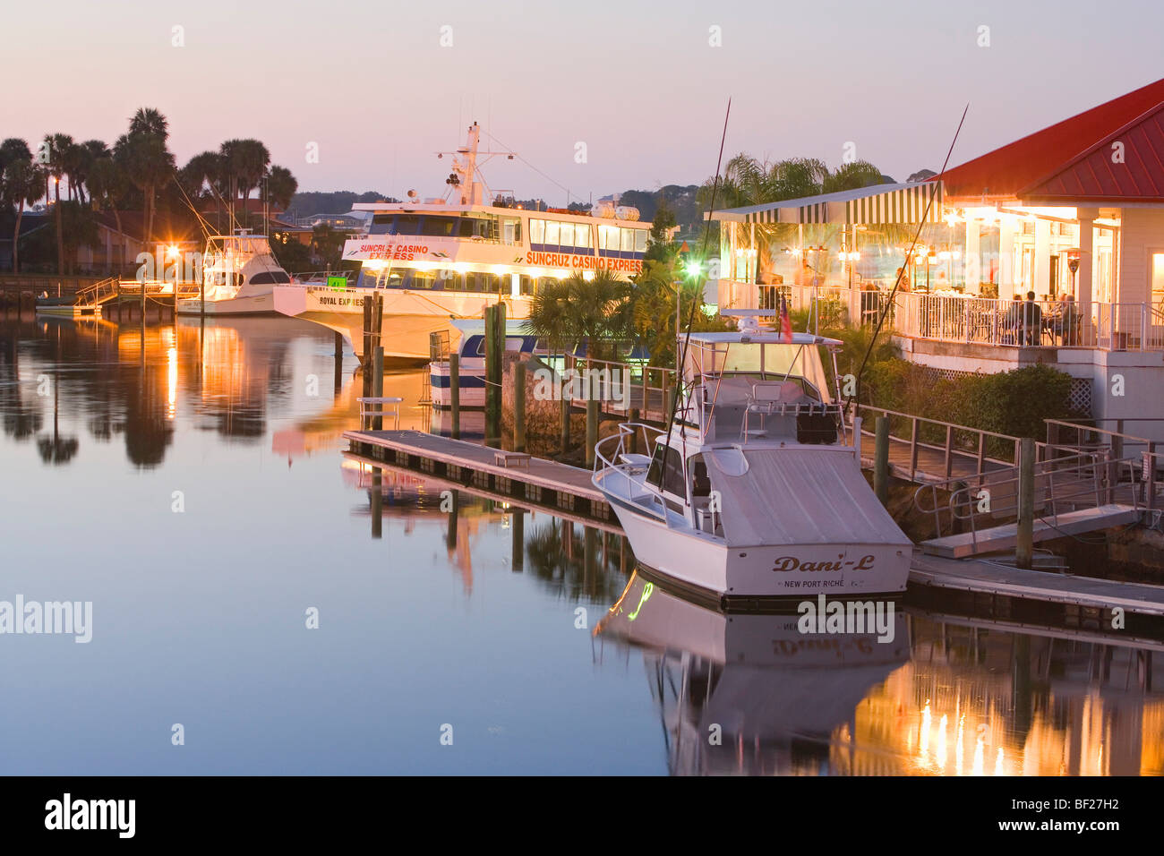 The illuminated Catches Waterfront Grille restaurant on the waterfront in the evening, Tampa Bay, Port Ritchey, Florida, USA Stock Photo
