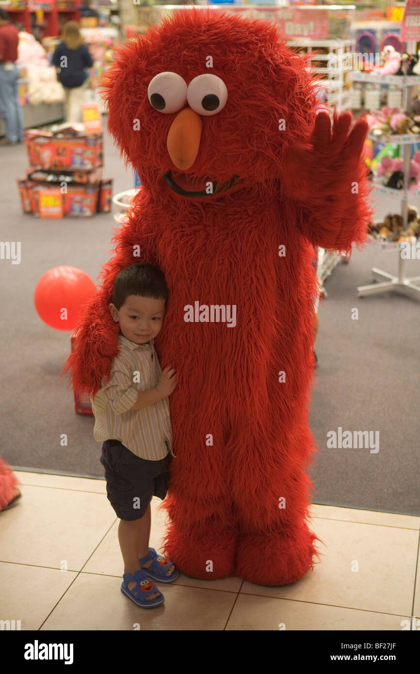 Little boy and Sesame Street figure at a shop, Sawgrass Mills Outlet Mall, Miami, Florida, USA Stock Photo
