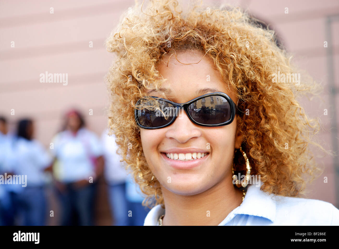 Smiling young woman wearing sunglasses, Puerto Rico, Carribean, America Stock Photo