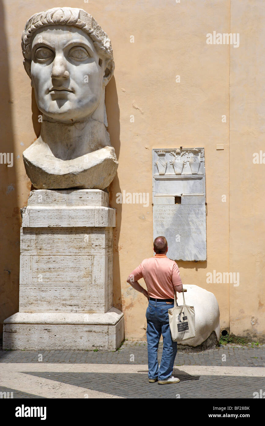 Tourist in front of the head of Constantine, Capitoline Museums, Palazzo dei Conservatori, Rome, Italy, Europe Stock Photo