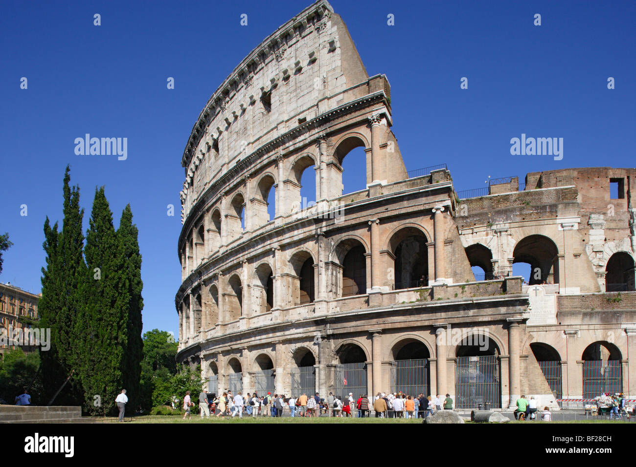 Tourists in front of the Colosseum under blue sky, Rome, Italy, Europe Stock Photo
