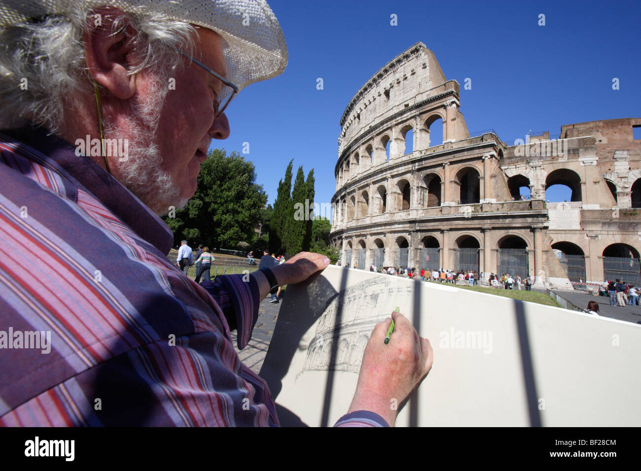 Mature man drawing in front of the Colosseum, Rome, Italy, Europe Stock Photo