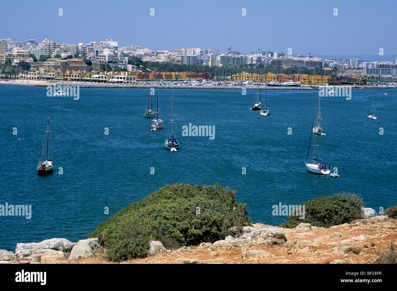 The mouth of Portimão harbour in southern Portugal's Algarve province. Across the bay is Portimão marina and Praia da Rocha Stock Photo