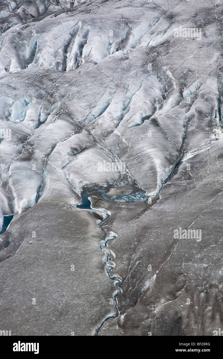 A small creek and structures on the Aletsch Glacier, Canton of Valais, Switzerland Stock Photo
