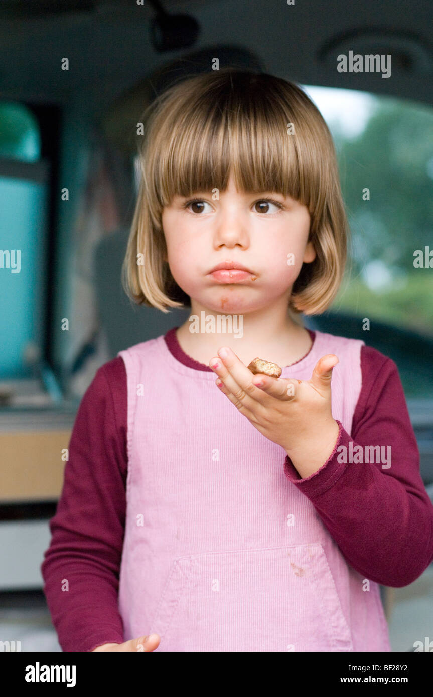 Girl (4-5) eating a biscuit, Bavaria, Germany Stock Photo