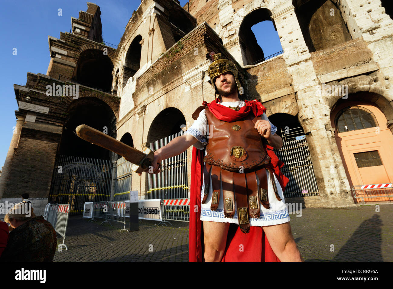 Man wearing uniform of Roman legionarie standing near Colosseum, Rome, Italy Stock Photo