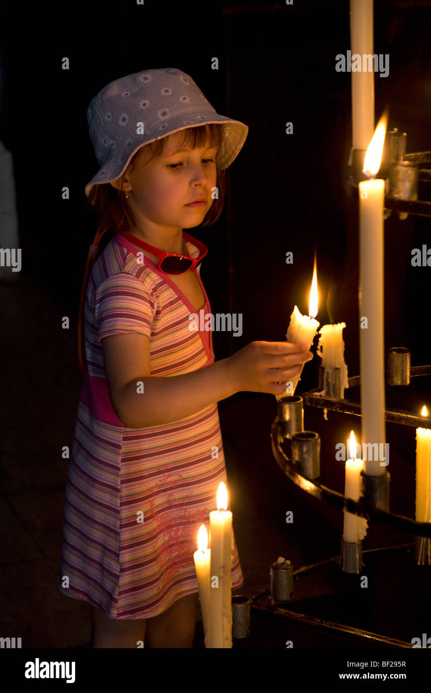 child and candle in the church Stock Photo Alamy