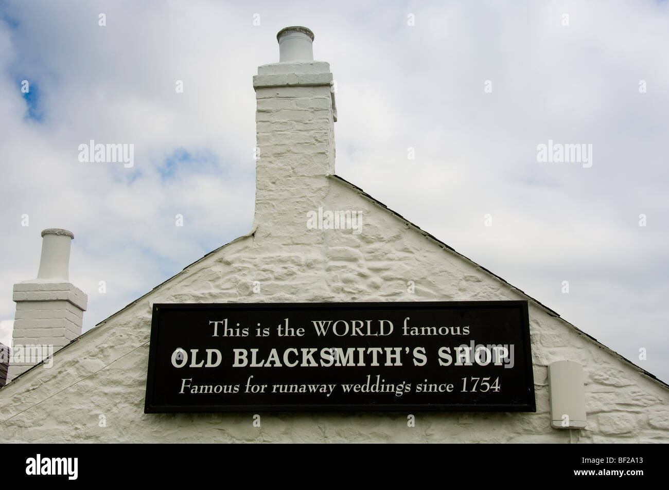 Close up of sign on the gable end of the Old Blacksmith's shop, Gretna Green, Scotland, UK Stock Photo