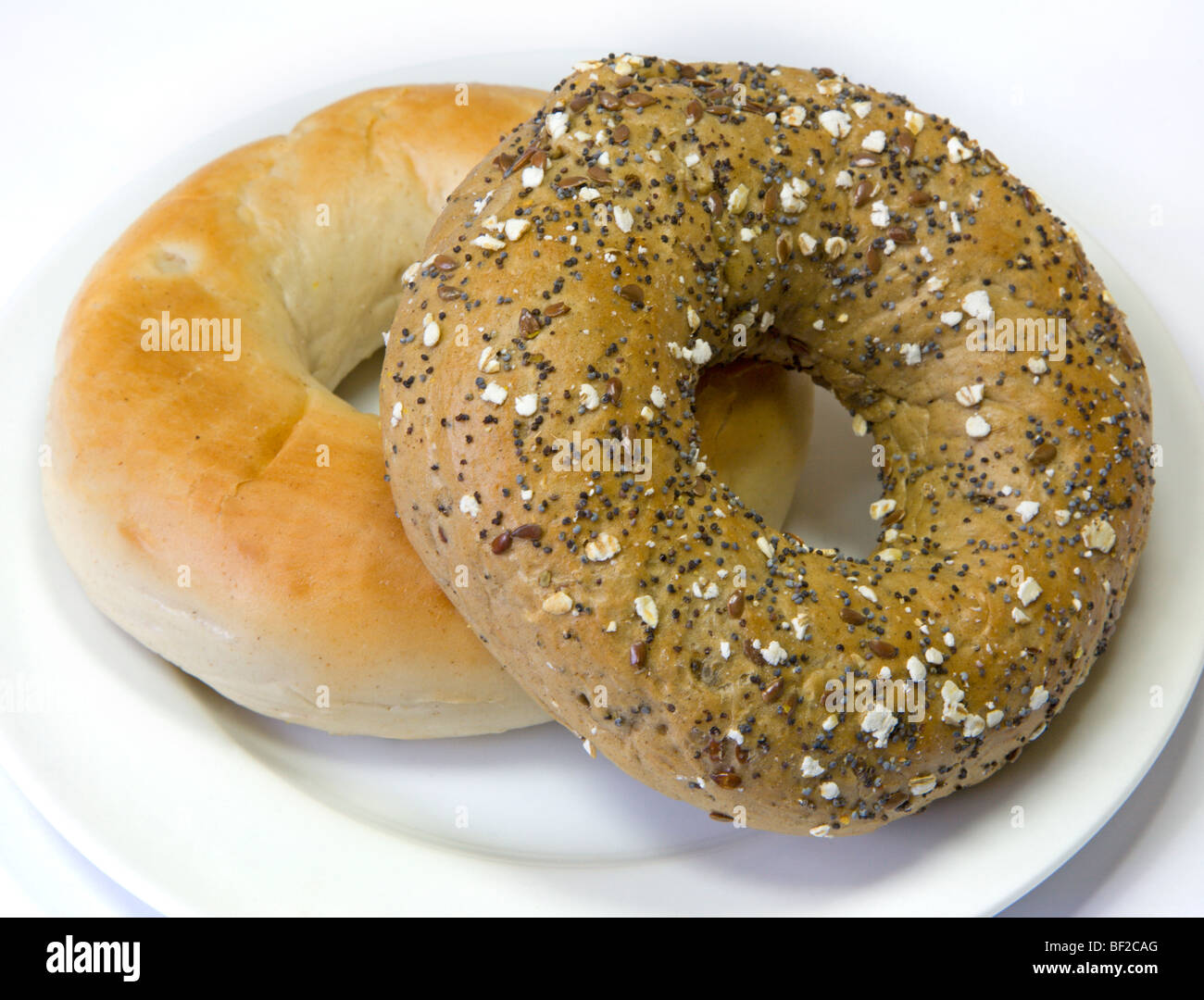 Plain and Granary Bagels on White Plate Stock Photo
